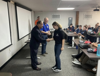 JROTC Cadets receiving Air Camp coins from Rafi Rodriguez (foreground) and Air Camp Board Member Lt Gen (Ret) Dick Reynolds